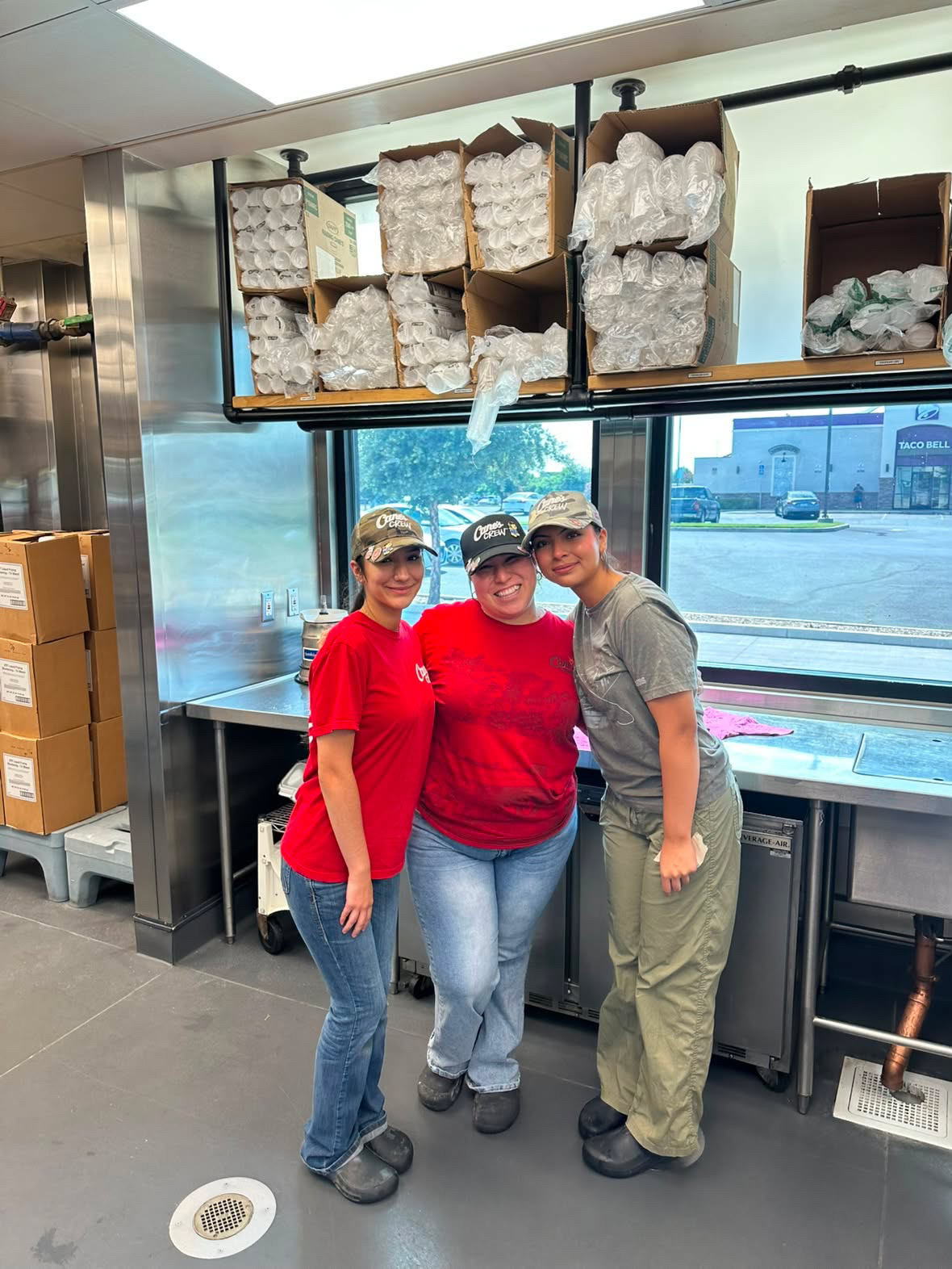 Alondra Duran with coworkers during her work experience in a restaurant kitchen