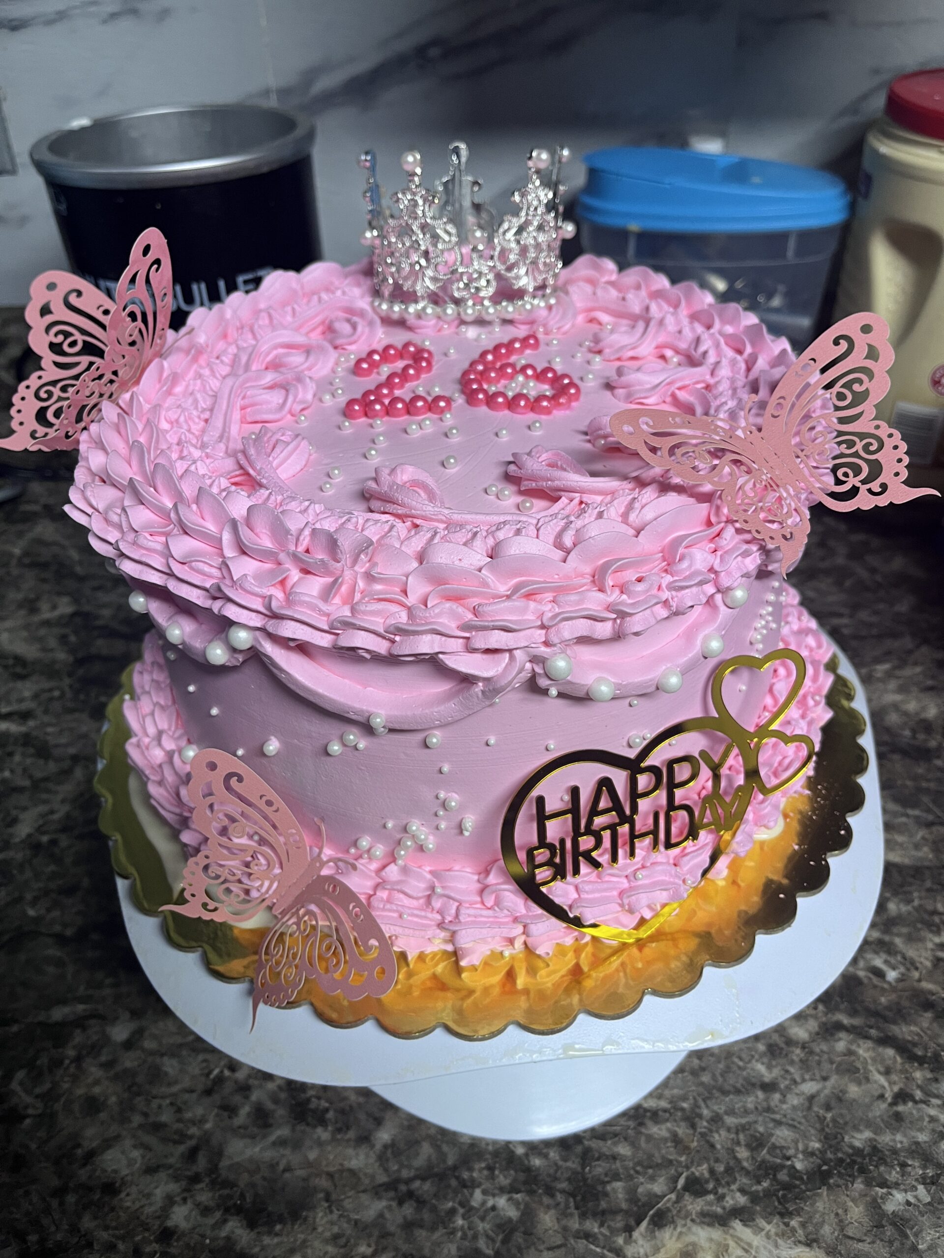 Pink decorated cake with pearl accents